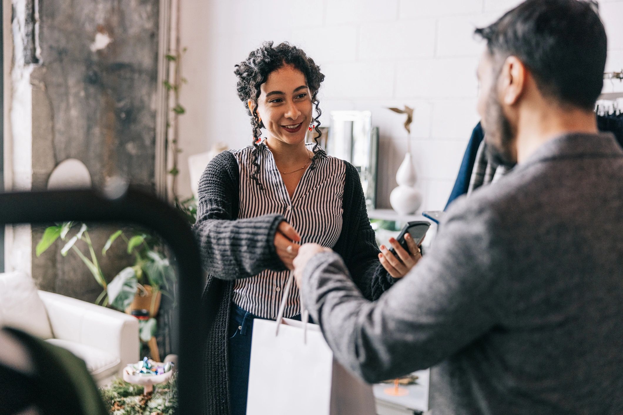 happy people picking up party rental items at a shop